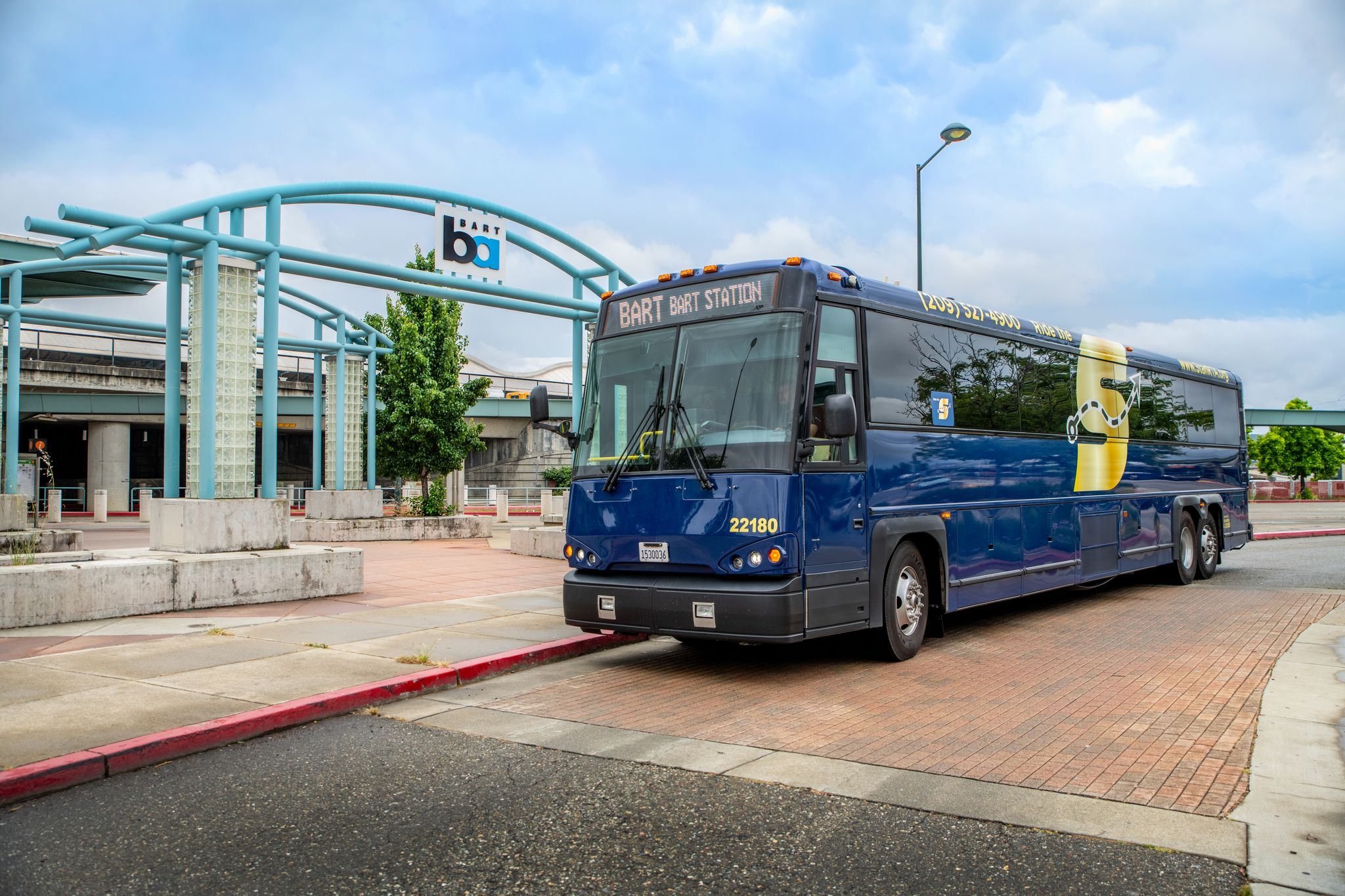 Image of The S BART Commuter bus parked in front of the BART station