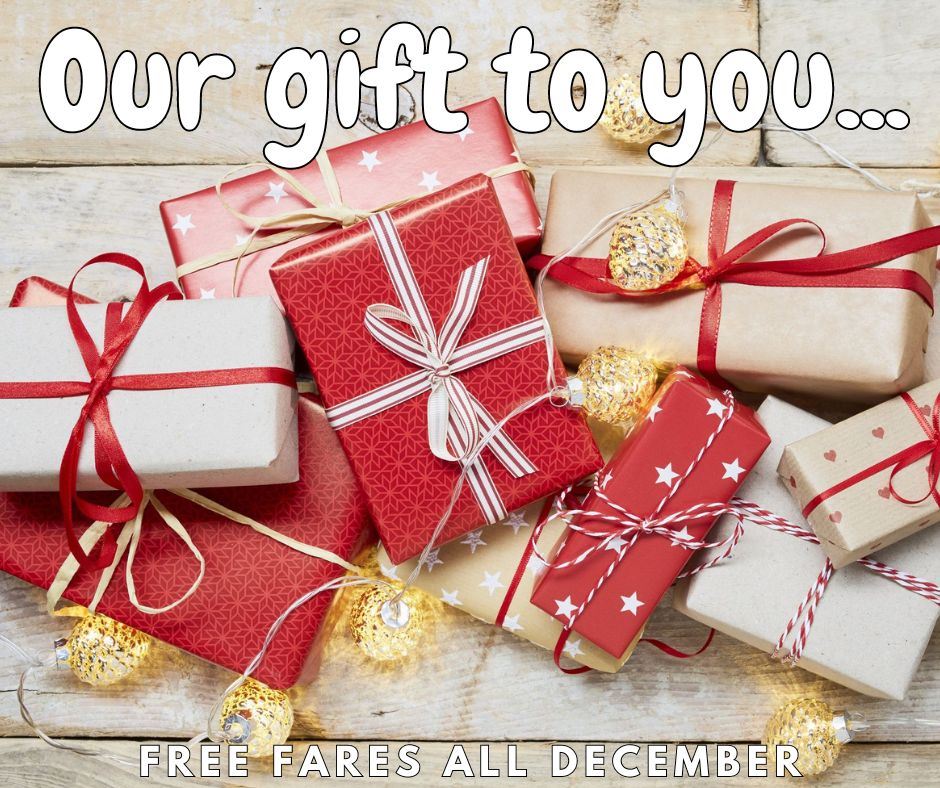 Our gift to you...free fares all December, image of a pile of wrapped gifts and string lights