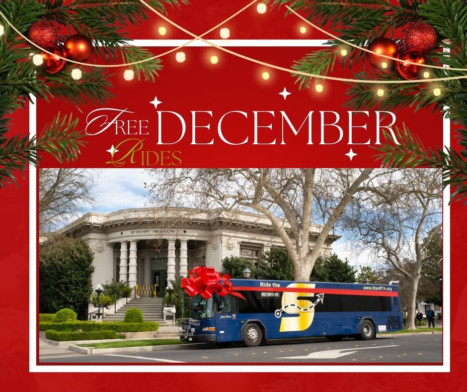 Free December rides, image of The S bus with a red ribbon in front of the McHenry Museum