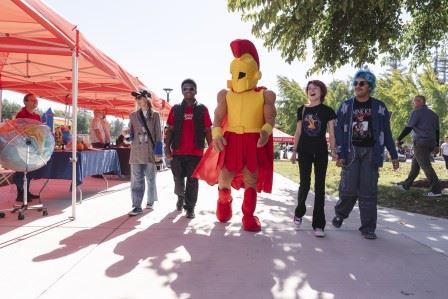 Image of CSU Stanislaus mascot walking with students