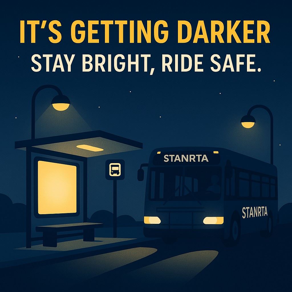 It's getting darker, stay bright ride safe, image of a cartoon StanRTA bus at a bus stop in the d
