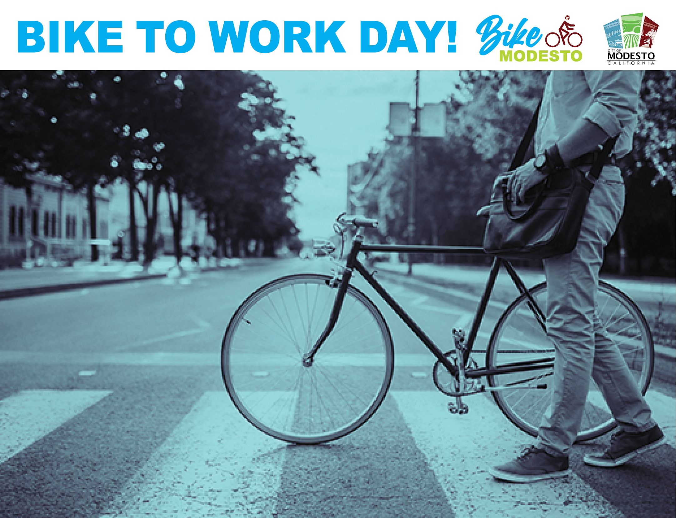 Man walking bike across street in crosswalk. Bike To Work Day.