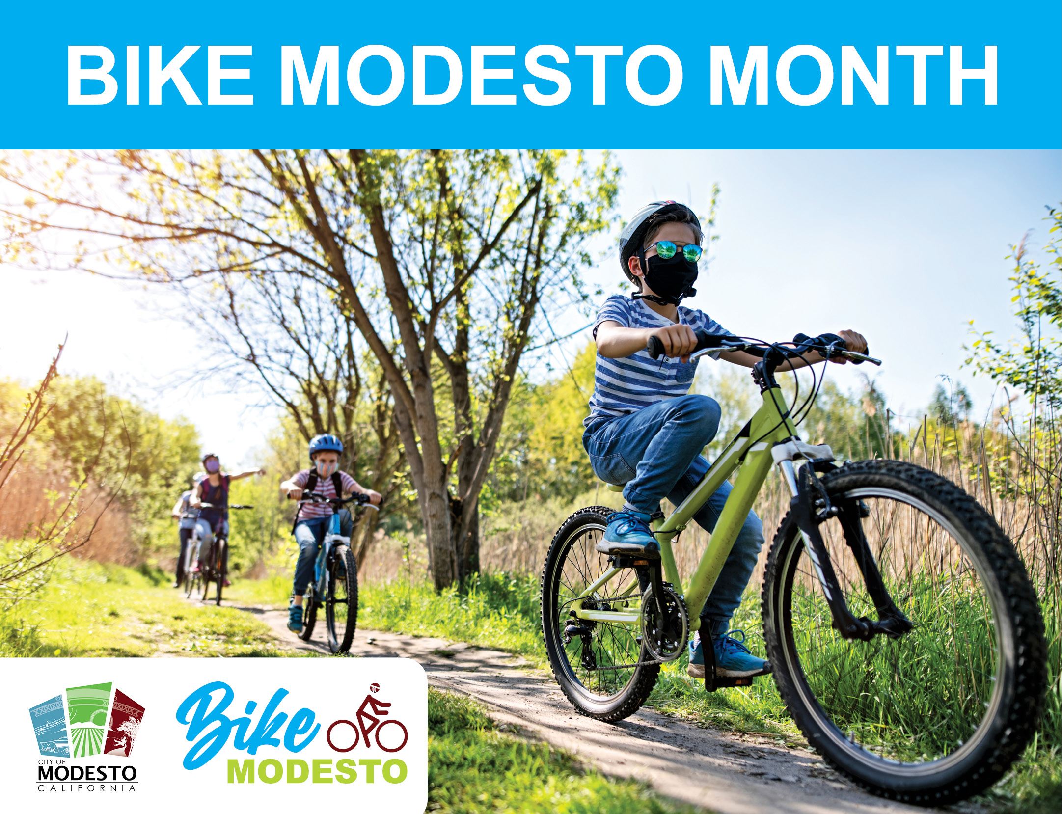 Four cyclists riding on a dirt path in a green field. Bike Modesto Month